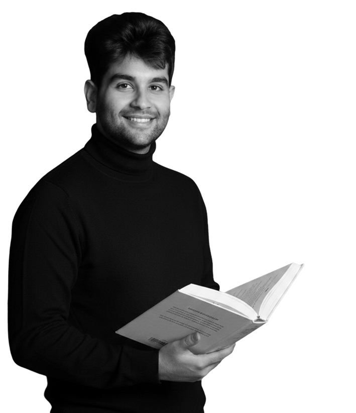 Mr Aryaman in black and white, jolly-smile with a book.